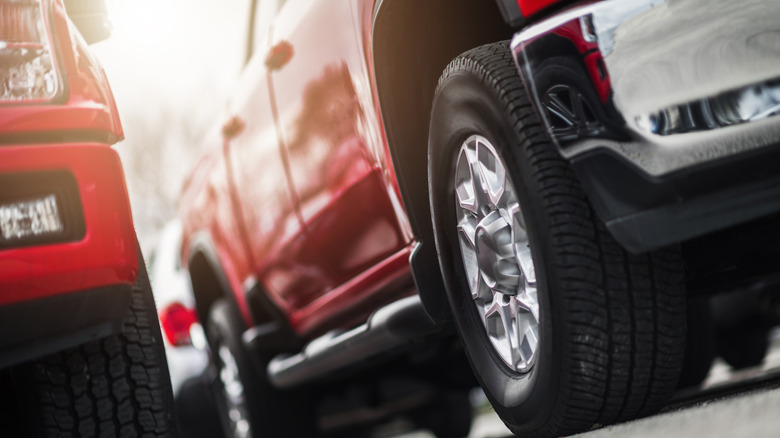 Low angle view of pickup trucks parked in lot