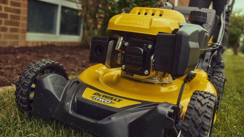 close-up of a DeWalt 21-inch 163cc RWD Self-Propelled mower cutting a yard