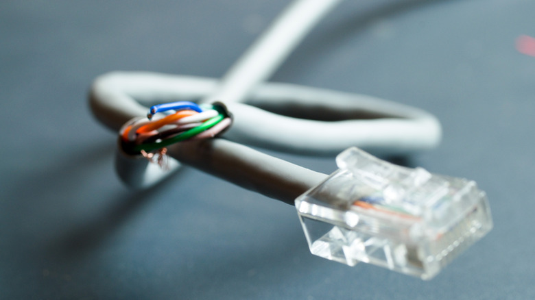broken grey ethernet cable with its internal wiring exposed