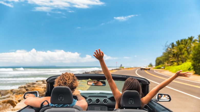 couple driving on coastal road