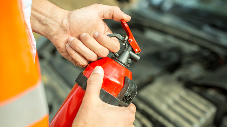 Person holding a fire extinguisher