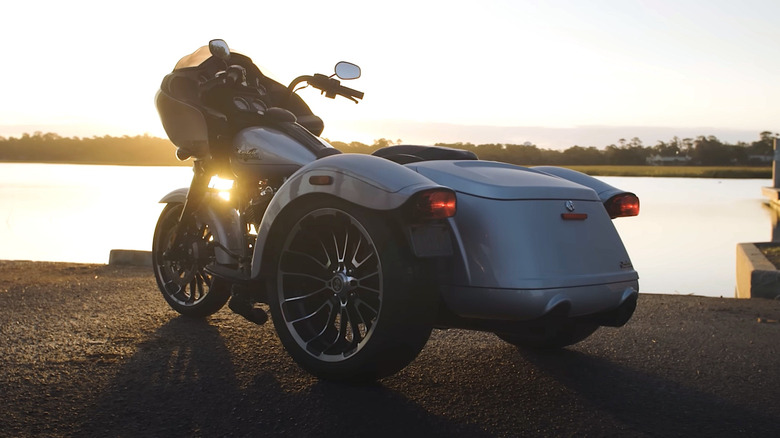 Harley-Davidson trike parked in front of river