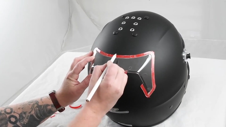 A helmet with aftermarket spoiler being installed