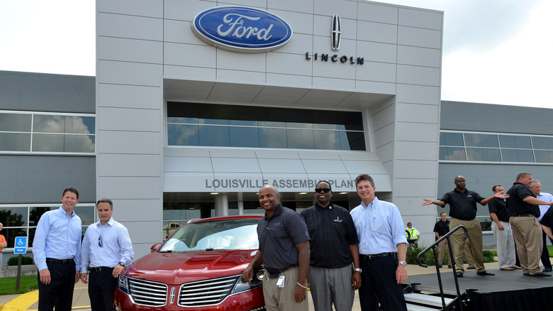 Ford and Lincoln assembly plant with Lincoln car and executives