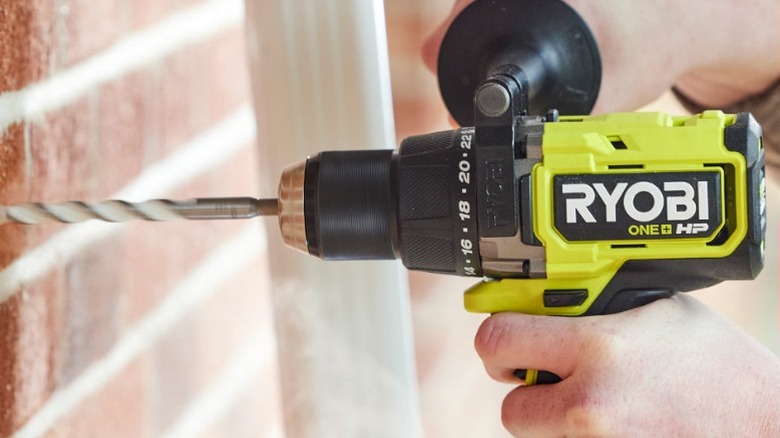Ryobi drill driving into brick