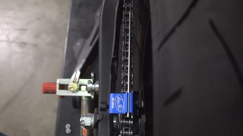 A wheel alignment tool on a motorcycle tire.