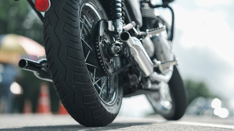 A close-up of a parked motorcycle's tires.