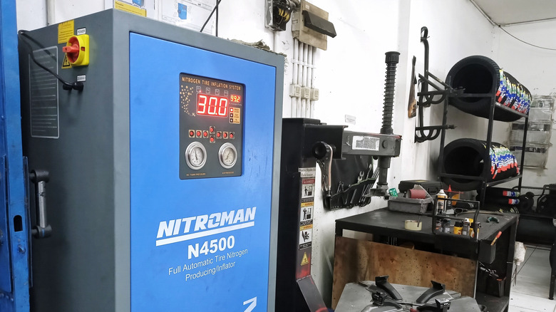 blue nitrogen tire inflator machine reading 30 psi placed inside a tire workshop