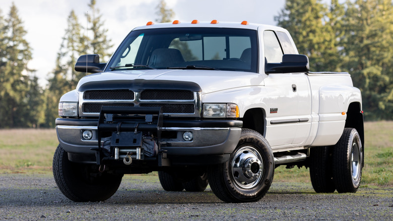 White pickup truck on gravel and grass
