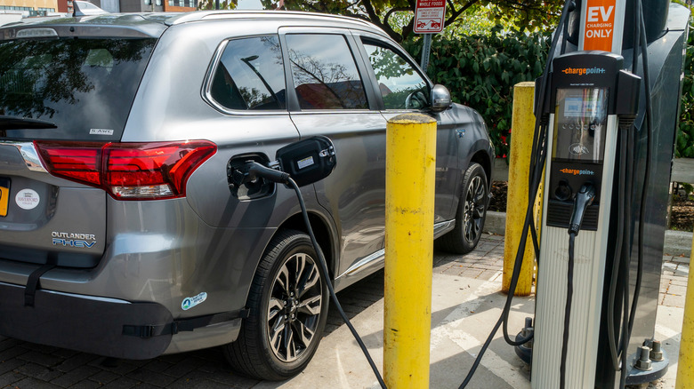 A Mitsubishi Outlander PHEV connected to an EV charger