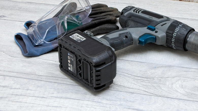 Unused drill with power tool battery connected