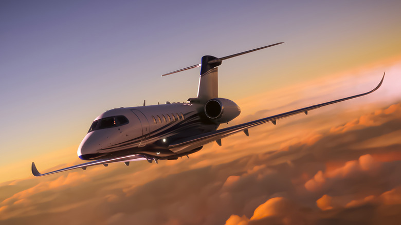 White private jet in flight above the clouds