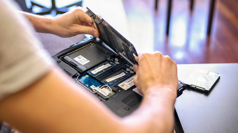 Person closing back of laptop