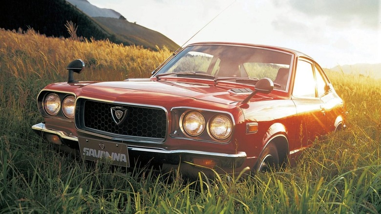 1971 Mazda RX-3 parked in grassy field, front-left view