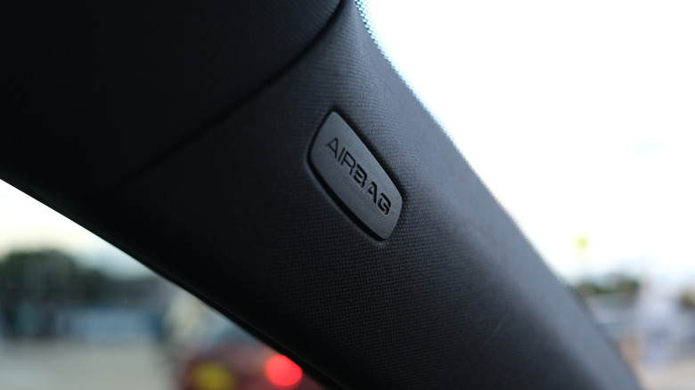 Airbag logo on the door frame of a car.
