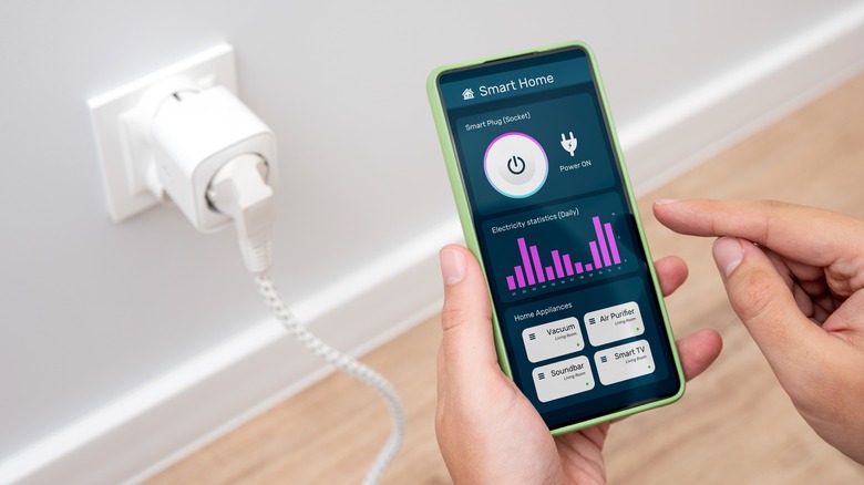 Person using app to monitor smart plug