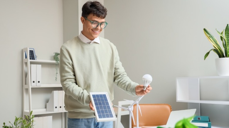 A man with a bulb and a solar panel