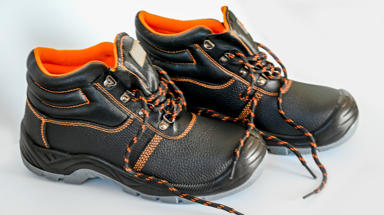 Pair of steel toe boots with orange inside lining