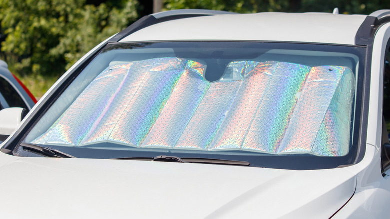 A car with a sunshade on the windshield.