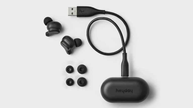 Heyday earbuds next to their case with charging wire and earbud tips