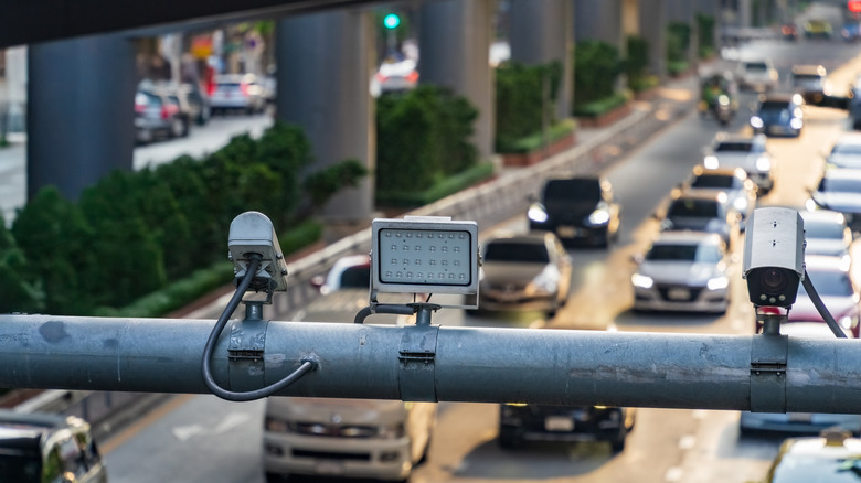 Traffic camera mounted above populated multi-lane city boulevard
