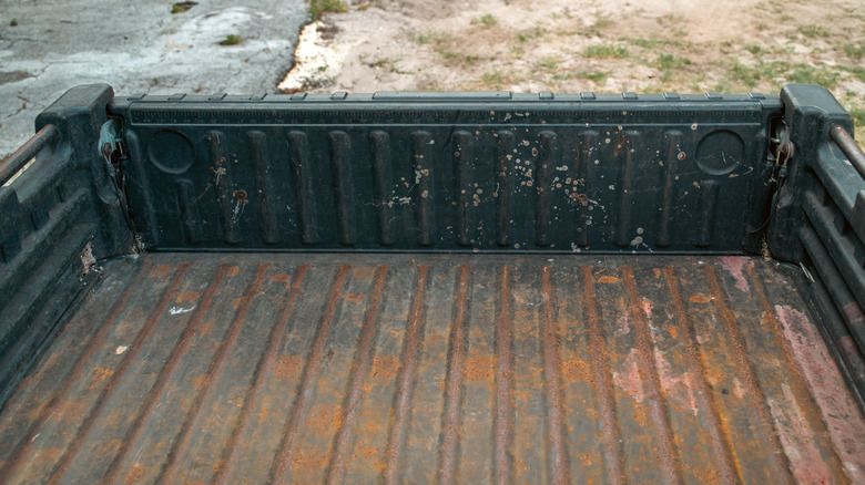 Close-up of a rusty metal truck bed floor