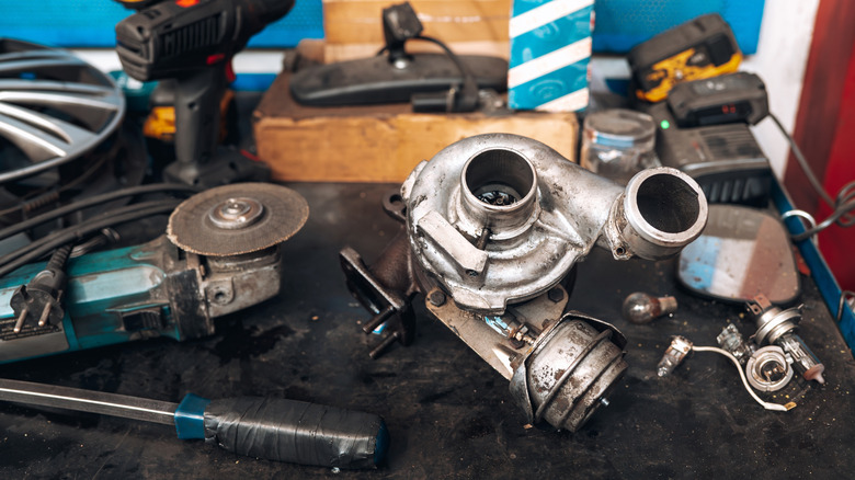 A turbocharger placed on a desk in a working environment.