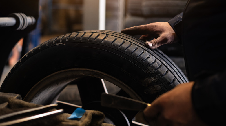 A mechanic balancing a tire