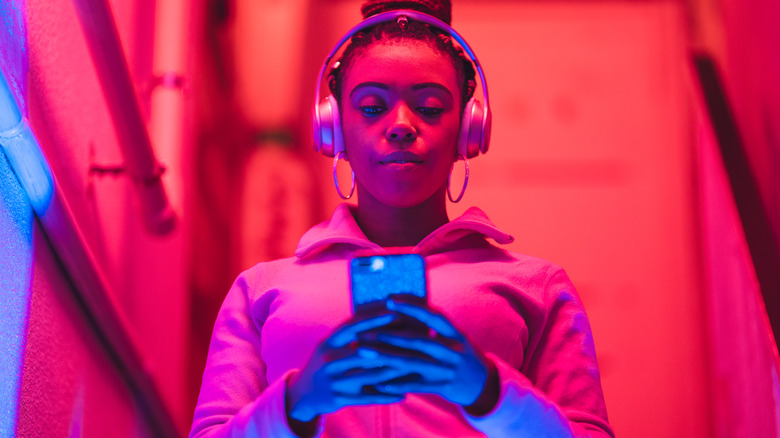 girl listening to bluetooth headphones