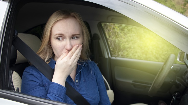 Car sick woman in passenger seat