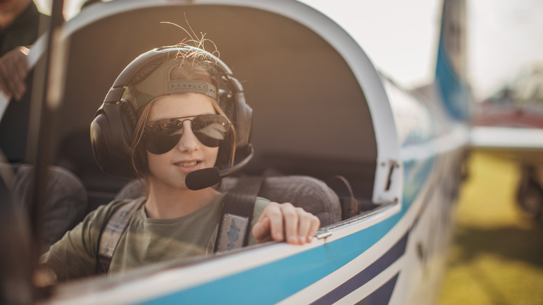 Teen in plane cockpit