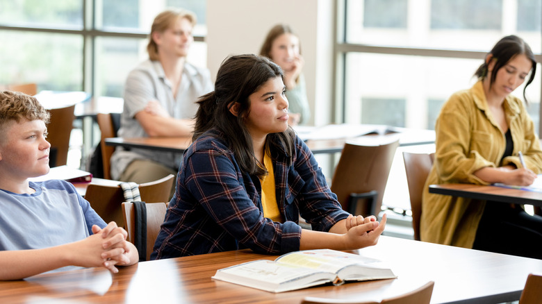 Teens sitting down in class