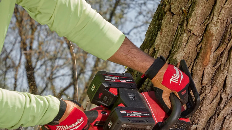 Worker using a Milwaukee M18 Fuel chainsaw
