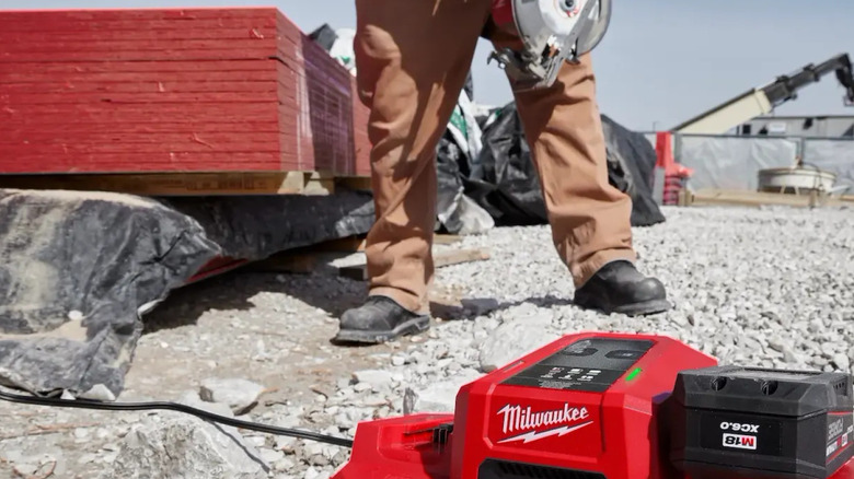 Milwaukee Dual Bay Simultaneous Super Charger on a gravel surface
