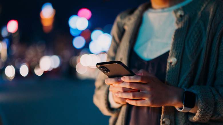 person on phone at night