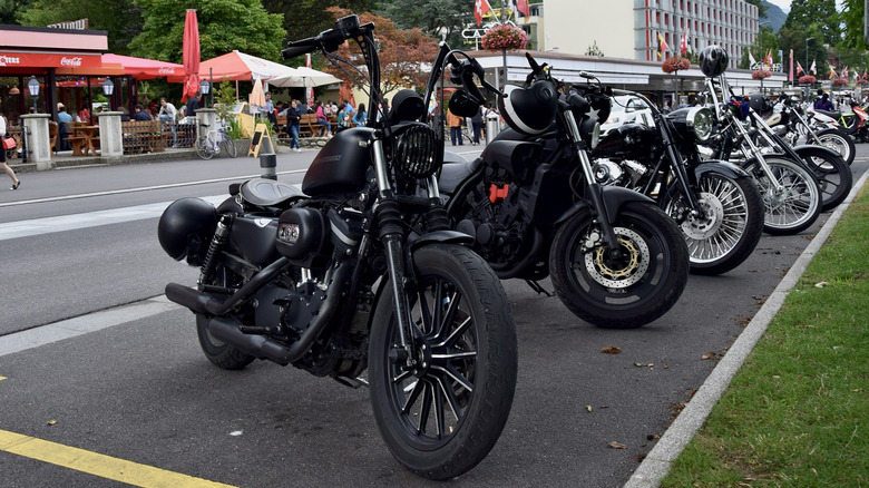 A line of Harley-Davidson motorcycles parked on a street.