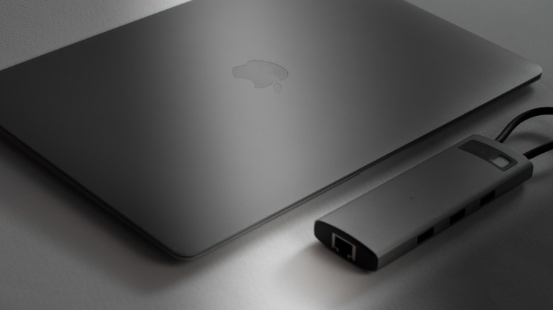 A third-party USB hub next to a MacBook