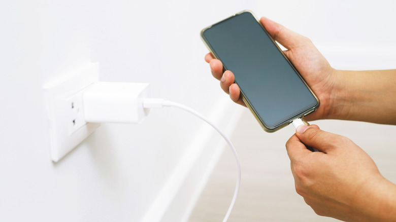 Plugging phone into outlet