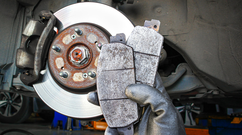A mechanic holding brake pads