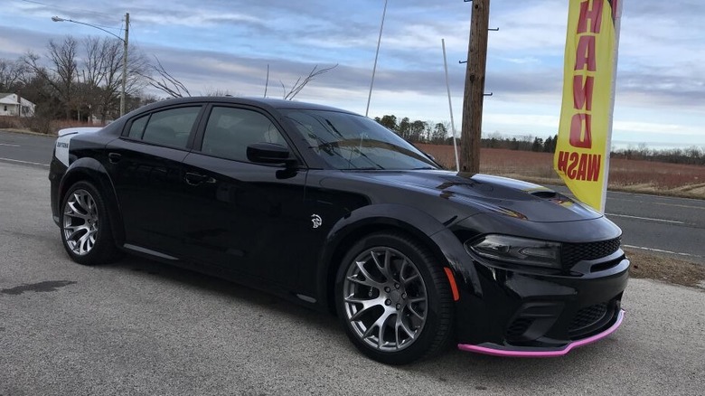 A Dodge Charger with pink splitter guards at the front.