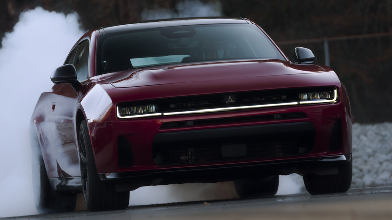 Front 3/4 view of two-door Dodge Charger doing a burnout on a drag strip