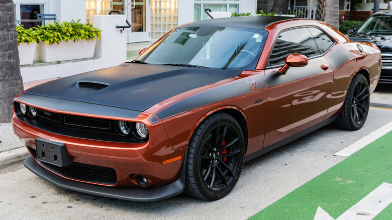 Orange Dodge Challenger Hellcat parked on the street