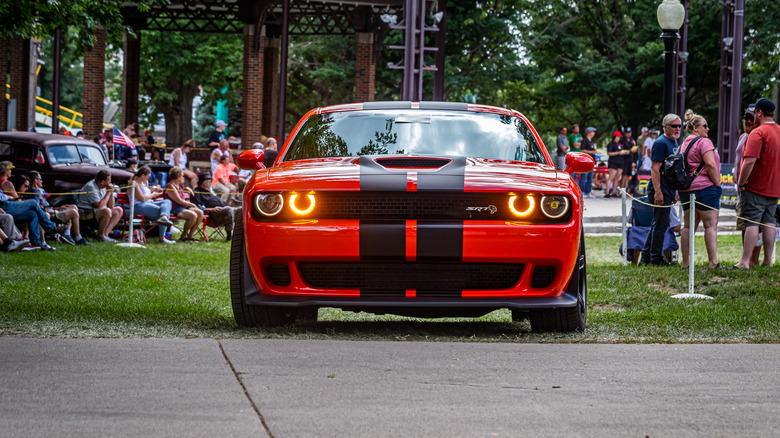 A red Dodge Challenger at a fairground