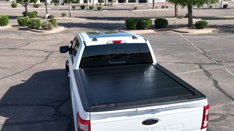 A white Ford F-150 with a tonneau cover