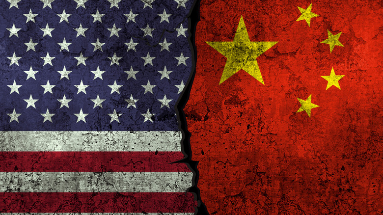 Chinese and American flags in smoke shape on black background