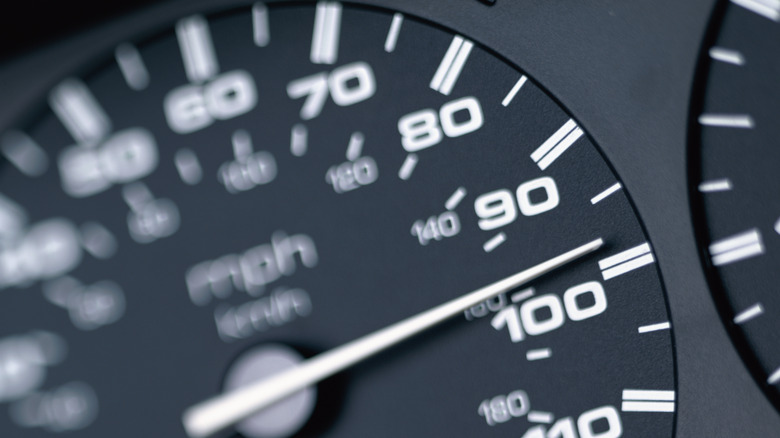 Close shot of speedometer reading 98 MPH