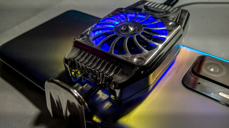 A phone with a fan cooler attached.
