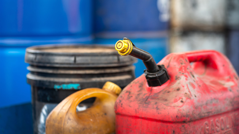 Old gasoline containers in a storage area.