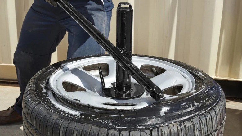 Person using Harbor Freight's Tire Changer to change a tire