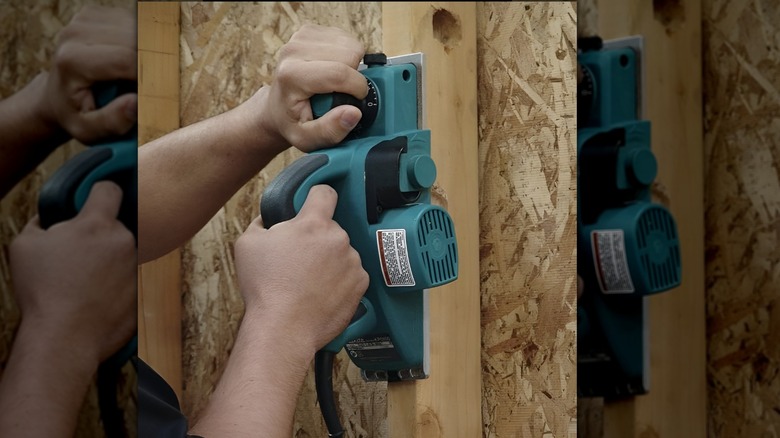 Makita door planner being used on wood wall